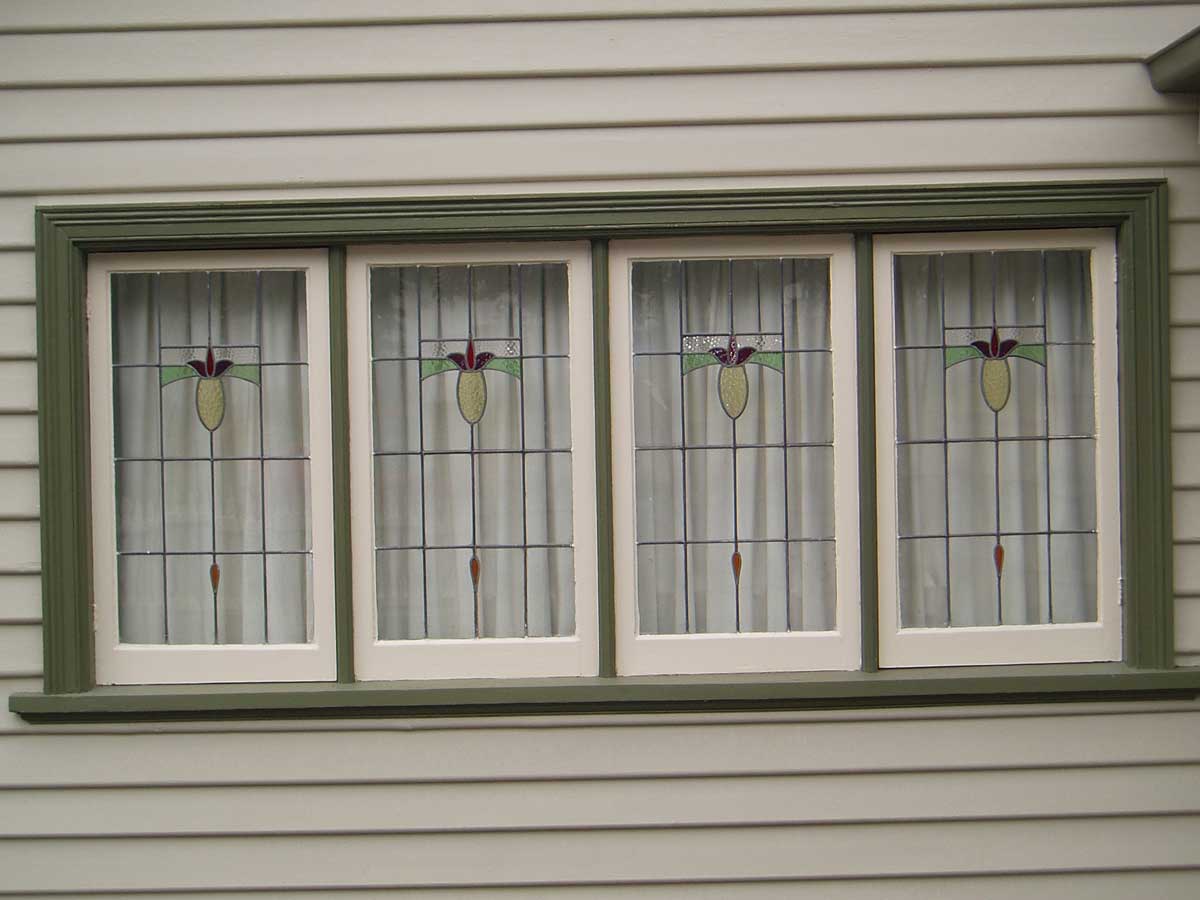 Restored leadlight window set with green-painted timber frame